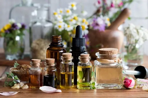 Essential oil bottles on a wooden trivet. Essential oils can be used as a natural rat repellent, but it's best to use them as part of a comprehensive rodent extermination approach. Contact Loyal Termite & Pest Control to get rid of rodents from your Virginia home.