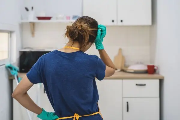 A discouraged homeowner holding head in hand upon discovering a mess from rodents. Cleaning up after rodents in Virginia is extremely important, as they leave behind filth that can make humans sick. Learn how to clean up after a rodent infestation from the experts at Loyal Termite & Pest Control.